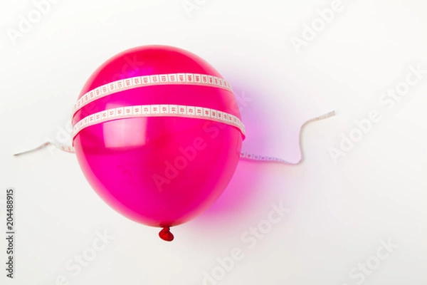 Obraz Balloon tied measuring tape on white background. Weight loss, slim body, healthy lifestyle concept. The waist measurement.