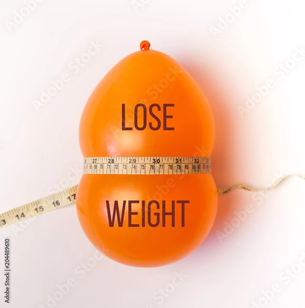 Obraz Balloon tied measuring tape on white background. Weight loss, slim body, healthy lifestyle concept. The waist measurement.