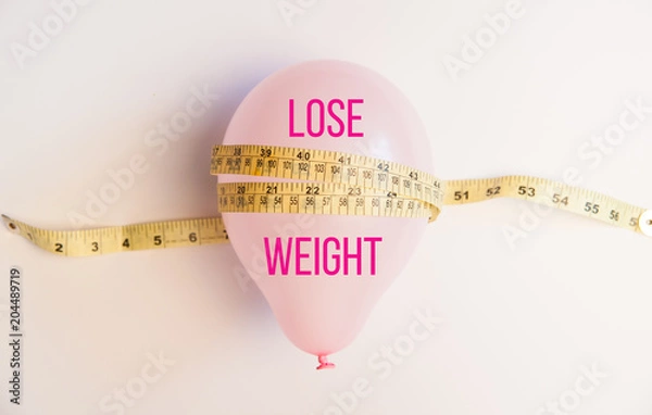Obraz Balloon tied measuring tape on white background. Weight loss, slim body, healthy lifestyle concept. The waist measurement.