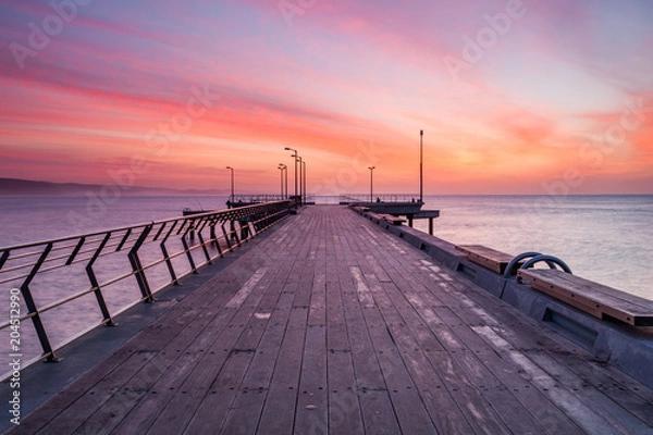 Fototapeta Sunrise over the Lorne Jetty on the Great Ocean Road in Victoria Australia on 22nd June 2010