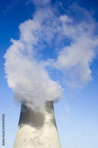 Fototapeta Cooling tower with water vapor over it