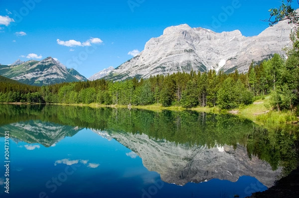 Fototapeta a lake with the mountain reflection on the water