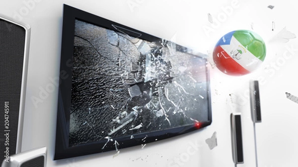 Obraz Soccer ball with the flag of Equatorial Guinea kicked through a shattering tv screen.(3D rendering series)