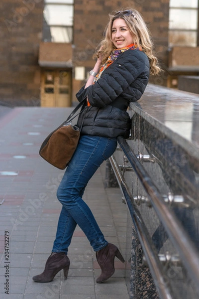 Obraz The girl is standing near the handrail