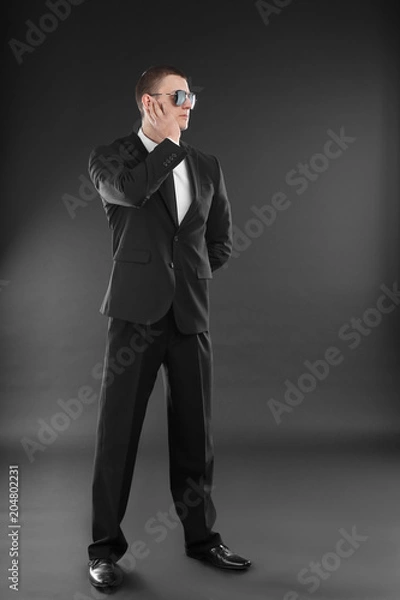 Fototapeta Male security guard in uniform on dark background