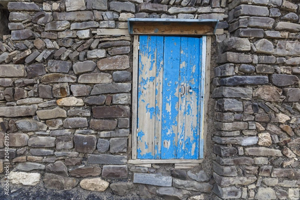 Fototapeta A door to the utility room in a house in the village of Khinalig