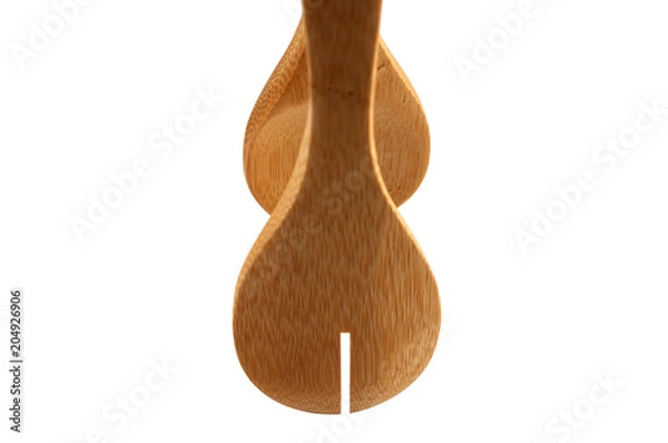 Obraz Kitchen forceps made of wood with a slot on a white background.