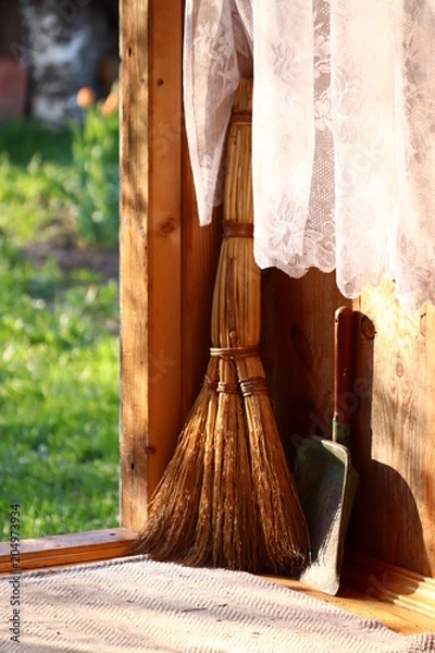 Fototapeta Vintage broom and scoop in the village on a sunny cleaning day