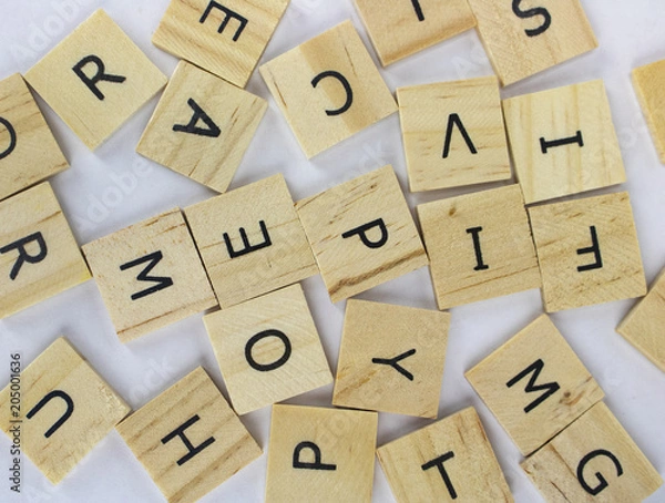 Obraz Tiles with letter in a pile on an isolated white background