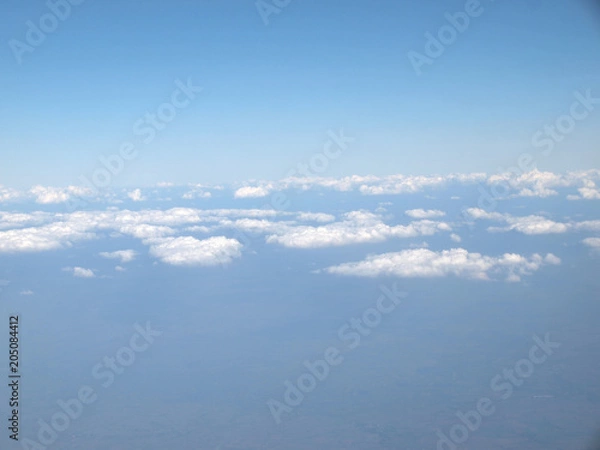 Obraz Blue sky with clouds, a view from airplane window