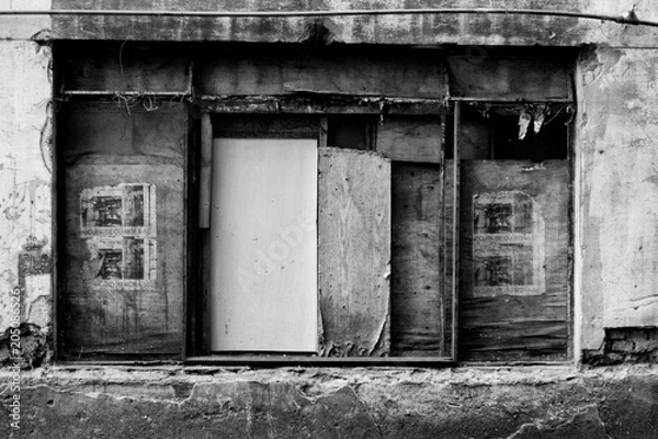 Obraz Black and white image of a dilapidated window with blinds made of wood tables.