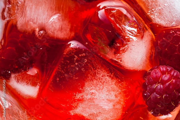 Obraz closeup photo of raspberries drink with ice . red macro food background