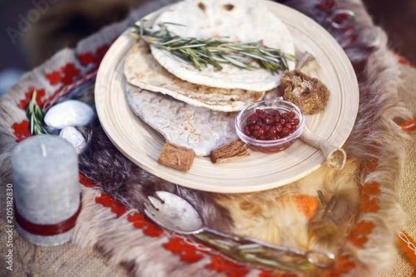 Fototapeta northern berries, bread cakes, covered table. Viking table