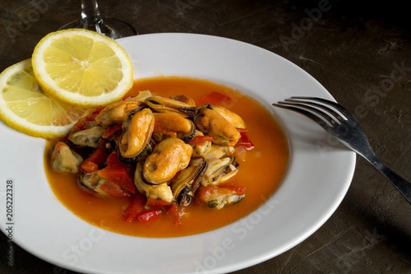 Fototapeta mussels in tomato sauce on a white plate