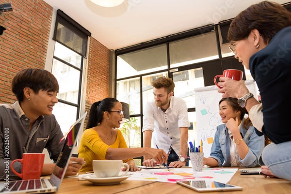 Fototapeta Multi ethnic business person group in casual suit discuss about internal meeting project in modern office. Project and Business concept.