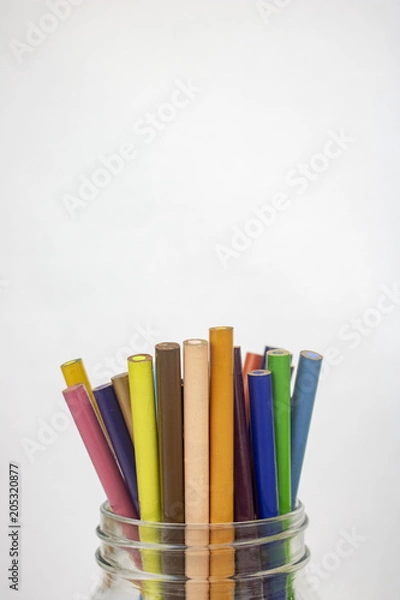 Obraz A jar of colored pencils on an isolated white background with room for text 