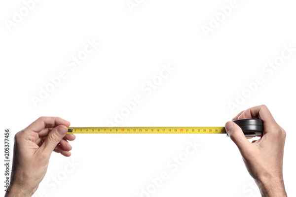 Obraz man's hand holding a tape measure on white background with clipping path and copy space
