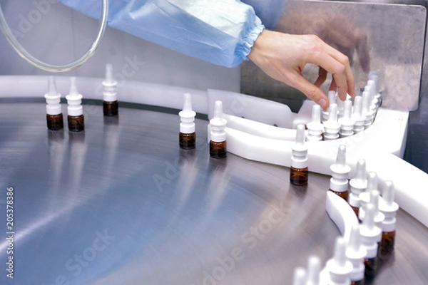Fototapeta The production line of the medicine. Filling interferon in bottl
