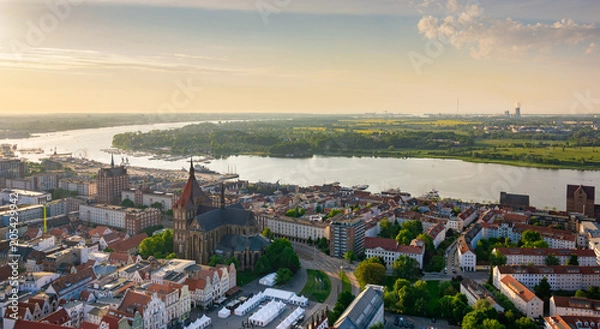 Fototapeta aerial view of rostock, germany in the evening - river warnow in the background