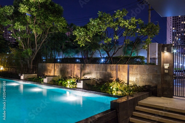 Fototapeta Lighting business for luxury backyard swimming pool.  Relaxed lifestyle with contemporary design by professionals.
