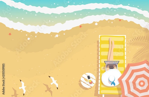 Fototapeta Woman with beach hat working on laptop, sitting on sun lounger on the beach with textured sand, curving sea waves, starfishes, shells and flying seagulls, from top view