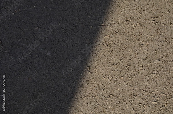 Fototapeta  Shadow on the road, Texture of the concrete road, Road at sunset, Abstract surface. Close up the darkness, Concrete texture, shadow line. Space for text.