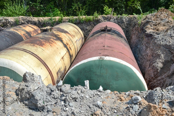 Fototapeta Large tank for gasoline in the excavated quarry for storage of petroleum products
