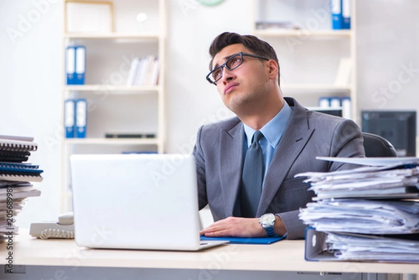 Fototapeta Overloaded with work employee under paperwork burden