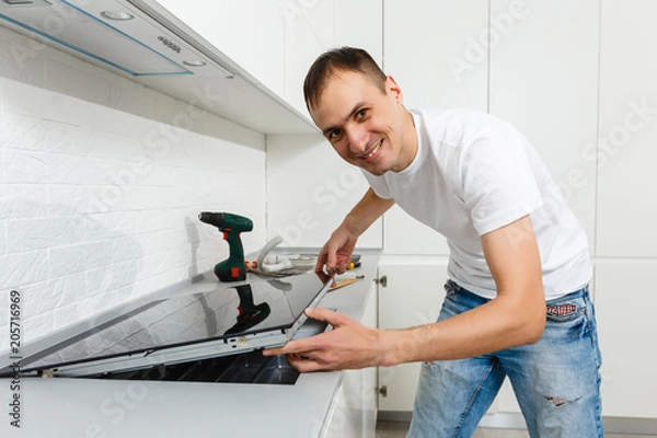 Obraz Installing new induction hob in modern kitchen