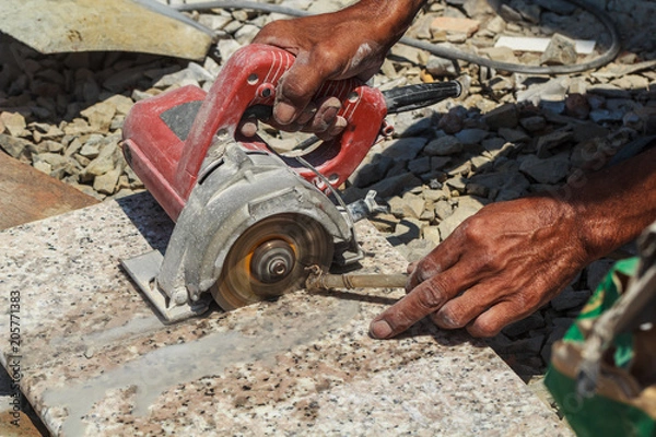 Obraz Workers are using stone cutting tools.