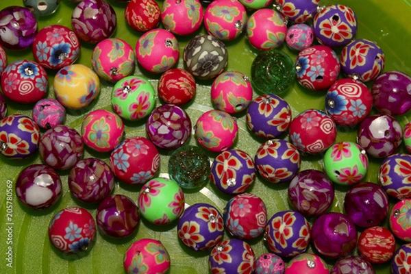 Fototapeta Colored Beads On Green Background. Seed Beads For Jewelry-Making, Closeup. Hobby, Handmade, Fine Arts Concept.Multi-Colored Beads Background.Abstract Colored Background.Colorful Beads. 