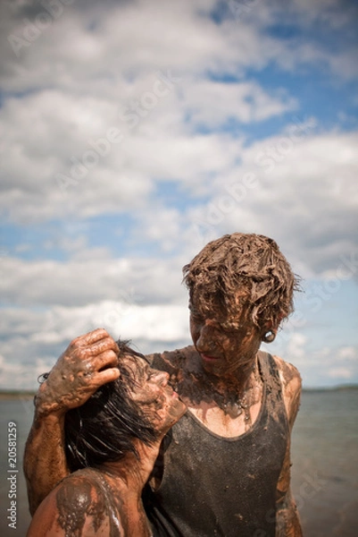Fototapeta couple playing in the mud