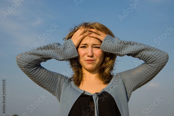 Obraz depressed young model holding her head crying