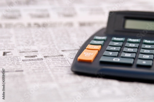 Obraz Newspaper page of classified ads and calculator