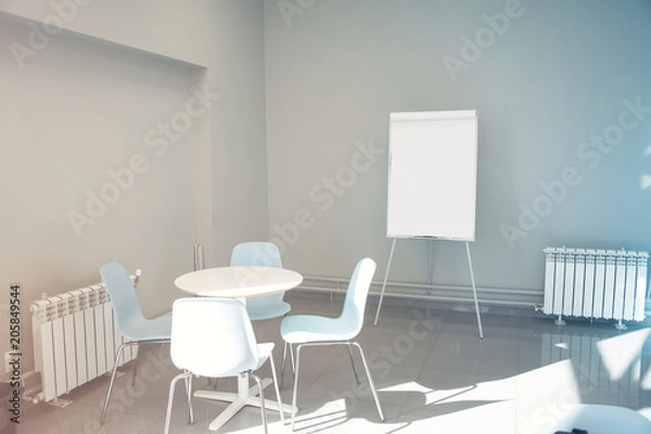 Fototapeta Empty seminar room with chairs and whiteboard for a presentation. Flipchart in empty poor office
