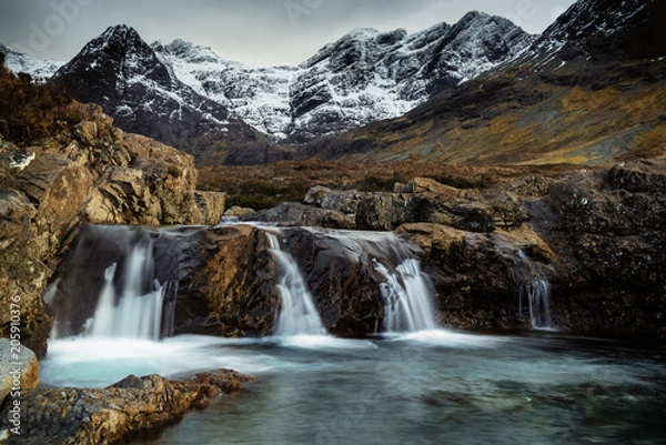Fototapeta Snowy Mountainous landscape with Waterfalls at Fairy Pools, Brittle River, Isle of Skye, Scot