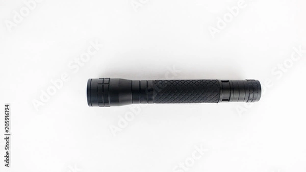 Obraz A black flashlight on an isolated white background
