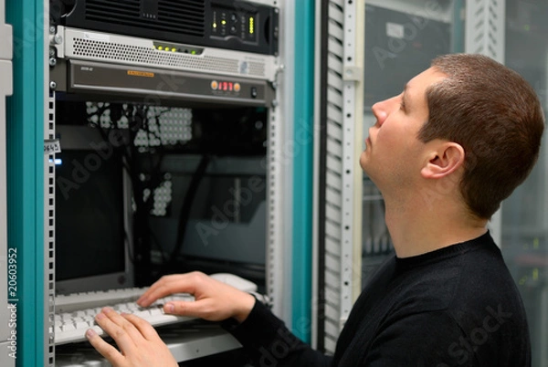 Fototapeta Network technician perform preventive maintenance to a server