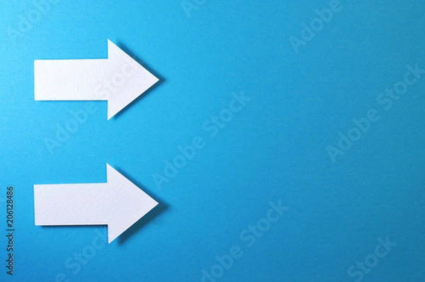 Obraz two solid arrows on blue background