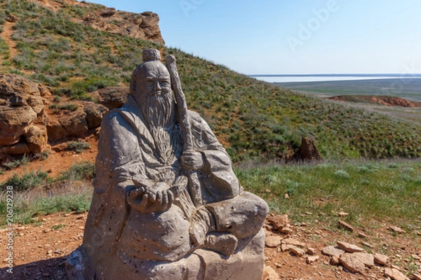 Fototapeta A statue of a Buddhist monk on the background of mount Bogdo. Astrakhan region, lake Baskunchak, Russia.