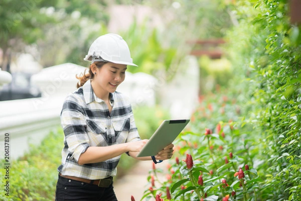 Fototapeta environment engineer with tablet ,inspection in workplace for architectural plan,sketching a constructions project at construction site,Business concept vintage color