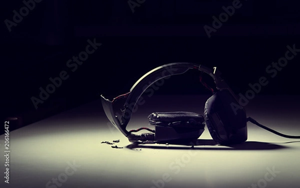 Obraz destroyed headphones on background.