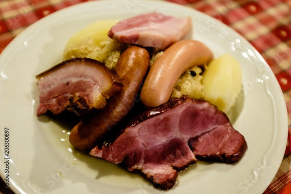 Obraz Choucroute garni, a typical alsacian plate, with sausages, bacon, choucroute and potatoes