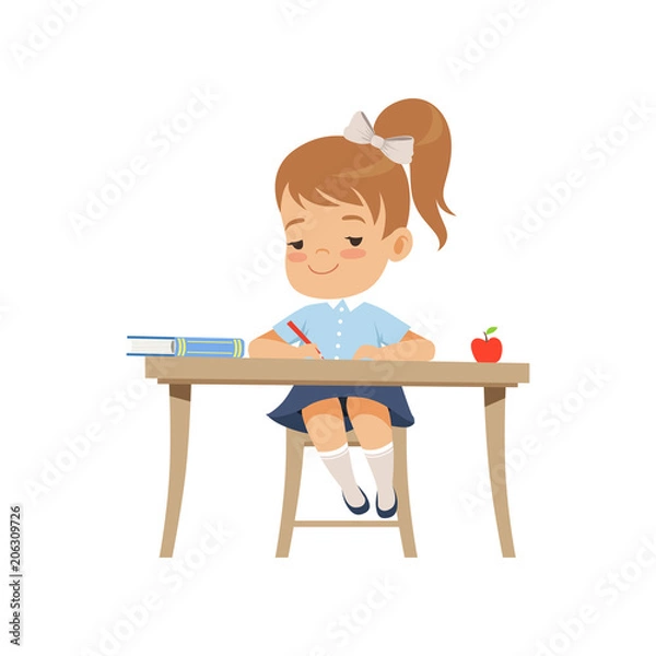 Fototapeta Cute girl sitting at the desk and writing, elementary school student in uniform vector Illustration on a white background