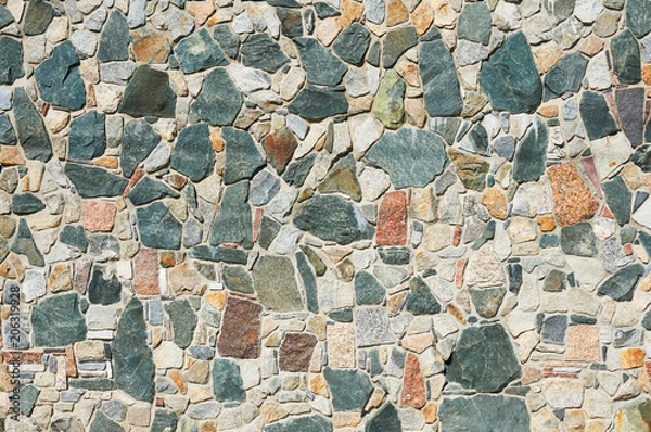 Obraz The wall is made of multicolored stones. Abstract background.