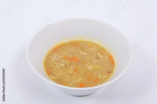 Fototapeta Soup with pasta and vegetables on a white