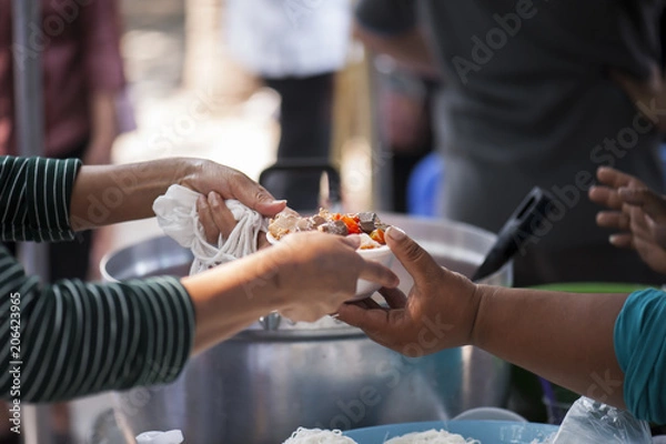 Fototapeta Feeding the poor Helping each other in society