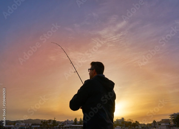 Fototapeta Angler with spinning rod fishing in Mediterranean