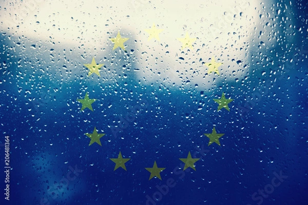 Obraz Texture of the European Union flag on the glass with drops of rain light.