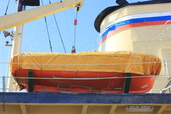 Fototapeta Orange Lifeboat on Russian Naval Ship. View of Lifeboat for Emergency Situationon Deck of Marine Ship. Emergency Evacuation and Life Saving Equipment Onboard Ship